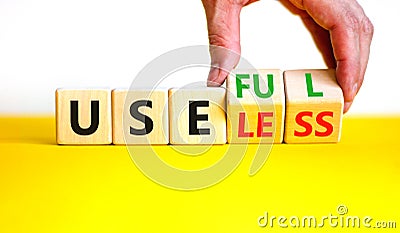 Useful or useless symbol. Concept words Useful or Useless on wooden cubes. Businessman hand. Beautiful yellow table white Stock Photo