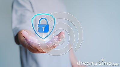 User hand show the shield security icon for security protection system on virtual screen. Stock Photo