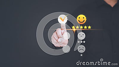 User hand touching the virtual screen on happy smile face icon to give satisfaction in service. Stock Photo