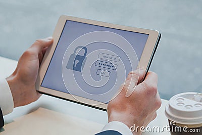 user typing login and password on digital tablet computer, data protection and internet security Stock Photo