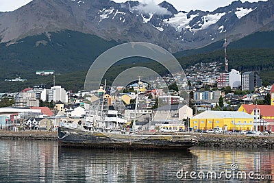 USHUAIA, ARGENTINA - april 04. 2018: Ships at the Port of Ushuaia, the capital of Tierra del Fuego, next to the little harbor town Editorial Stock Photo