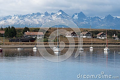 USHUAIA, ARGENTINA - april 04. 2018: Ships at the Port of Ushuaia, the capital of Tierra del Fuego, next to the little harbor town Editorial Stock Photo