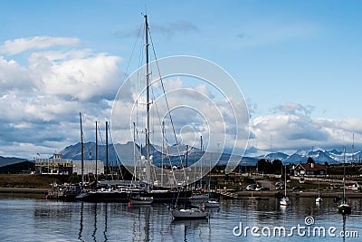 USHUAIA, ARGENTINA - april 04. 2018: Ships at the Port of Ushuaia, the capital of Tierra del Fuego, next to the little harbor town Editorial Stock Photo