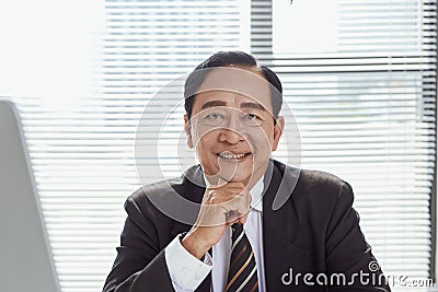 Usiness, people and technology concept - happy smiling businessman with computer office Stock Photo