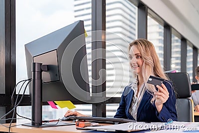 Usiness woman waiting for confirmation of her online order at office, Blogger shopping online and using credit card Stock Photo