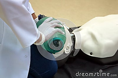 Using a Breathing bag Ambu by a student on a simulation dummy during basic life support with an automatic external defibrillator Stock Photo