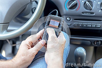 Using diagnostic car code reader to erase error codes and turn off check engine light Stock Photo