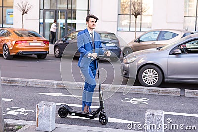 Using Electric Scooter on the street Editorial Stock Photo