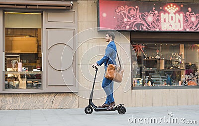 Using Electric Scooter on the street Editorial Stock Photo