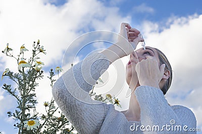 Using eyedropper to treat irritated eyes Stock Photo