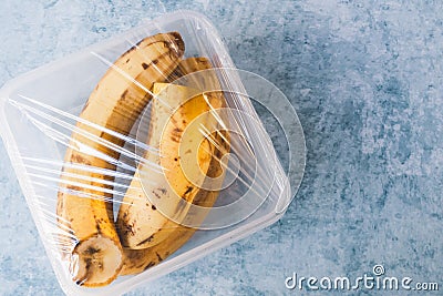 Using food film for bananas storage in fridge. Top view Stock Photo