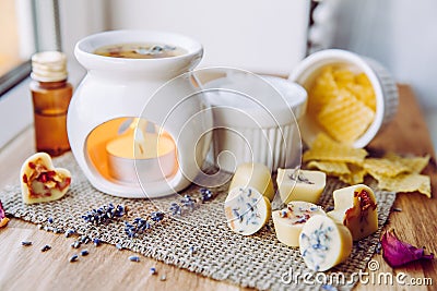 Using homemade mini wax melts in aromatherapy lamp diffuser at home interior concept. Stock Photo