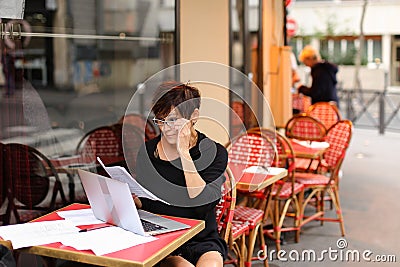 tired female employee of bank adds financial plan in laptop Stock Photo