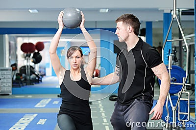 Using medicine ball with personal trainer Stock Photo
