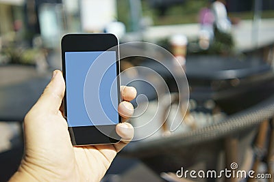 Using mobile phone in a cafe Stock Photo