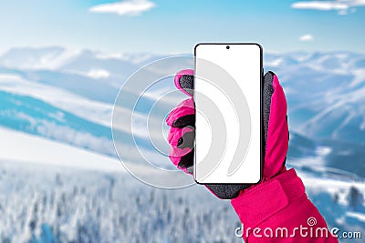 Using a mobile phone at the ski resort. Isolated display for promoting ski or mountaineering app Stock Photo