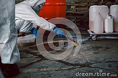 Using Sand or Sawdust to Absorbent for Oil, Acid, Chemical, Liquid Spills Cleanup. Steps for Dealing with Chemical Liquid Spillage Stock Photo