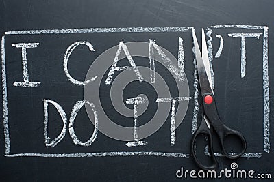 using scissors to remove the word can 't to read I can do it concept for self belief, positive attitude and motivation Stock Photo