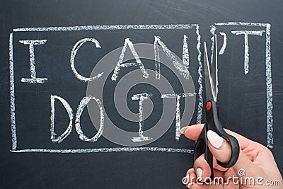 using scissors to remove the word can & x27;t to read I can do it concept for self belief, positive attitude and motivation Stock Photo