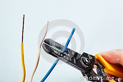 Using wire stripper cutter during electrical wiring installati Stock Photo