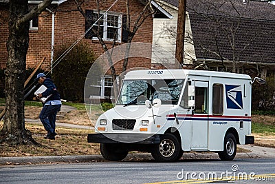 USPS Postal van with mailman - 2 Editorial Stock Photo