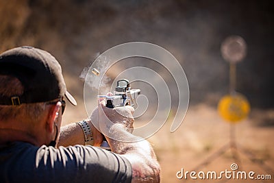 Shooting Steel Custom Glock 35 with brass and smoke Editorial Stock Photo