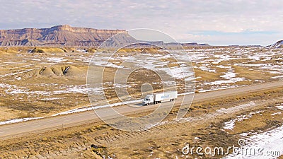 AERIAL: Walmart truck hauls cargo across the Utah desert on a sunny winter day. Editorial Stock Photo