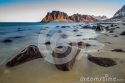 Utakleiv beach with rocks at sunrise Stock Photo