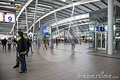 Passengers inside large modern railway terminal concourse Editorial Stock Photo
