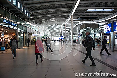 Passengers inside large modern railway terminal concourse Editorial Stock Photo