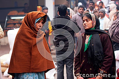 Young and elderly women stand on the busy street Editorial Stock Photo