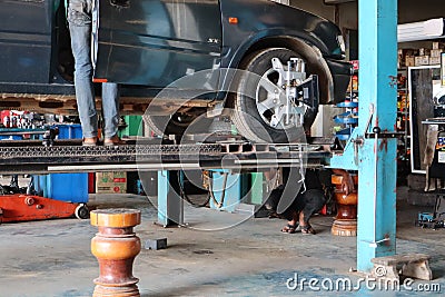 Uttaradit, Thailand, May 4, 2019, system check Suspension of the car, wheel balancing center, car maintenance, garage, repairman Editorial Stock Photo