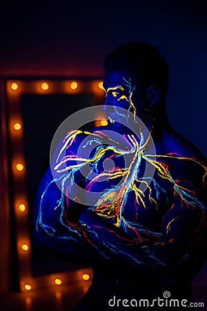 UV patterns body art of the circulatory system on a man`s body. On the torso of a muscular athlete, veins and arteries are drawn Stock Photo