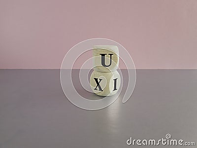 UX design or UI design. Turned cube and changed the words 'UX' to 'UI'. Stock Photo