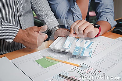 UX or UI designers designing on their smartphone application layout prototype project Stock Photo