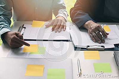 UX or UI designers designing on their smartphone application layout prototype project Stock Photo