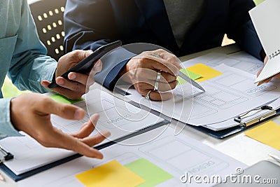 UX or UI designers designing on their smartphone application layout prototype project Stock Photo