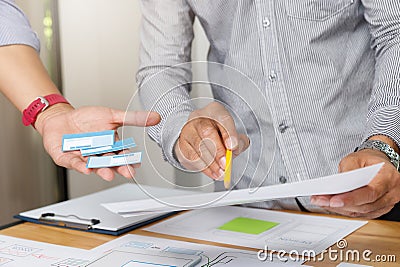 UX or UI designers designing on their smartphone application layout prototype project Stock Photo