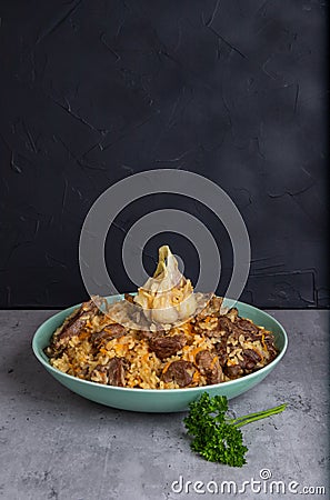 Uzbek national rice dish plov prepared on plate, vertical Stock Photo