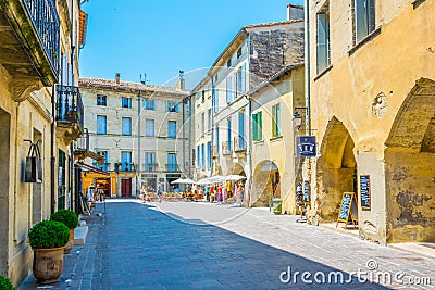 UZES, FRANCE, JUNE 20, 2017: People are strolling through a narrow street in the center of Uzes, FranceUZES, FRANCE, JUNE 20, 2017 Editorial Stock Photo