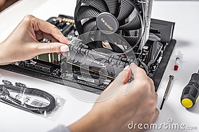 Installing random access memory into PC. Editorial Stock Photo