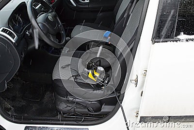 12v compact automobile electric pump lies on a seat in a car Stock Photo