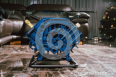 V8 Engine block table, painted in blue color. Stock Photo
