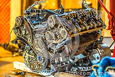 V8 engine out on hoist to get rebuilt Editorial Stock Photo