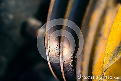 V-pulley with corrosion in the recesses close-up. Old worn double pulley tractor. Rust on iron parts of agricultural machinery Stock Photo