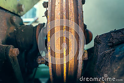 V-pulley with corrosion in the recesses close-up. Old worn double pulley tractor. Rust on iron parts of agricultural machinery Stock Photo