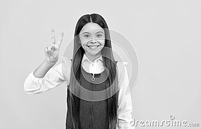 V is for victory. Happy girl child give Victory sign. School education Stock Photo