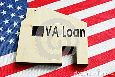 VA loan sign on the home and American flag. Stock Photo