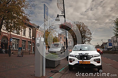 VAALS, NETHERLANDS - NOVEMBER 9, 2022: Selective blur on an electric car, an SUV, charging at a charging station used to fill with Editorial Stock Photo