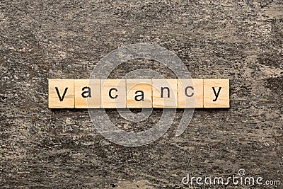 Vacancy word written on wood block. Vacancy text on cement table for your desing, concept Stock Photo